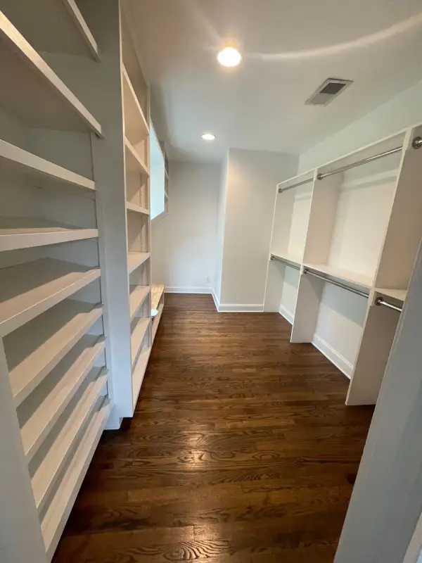 Walk-in pantry with white shelving and hanging rods, Brentwood, TN