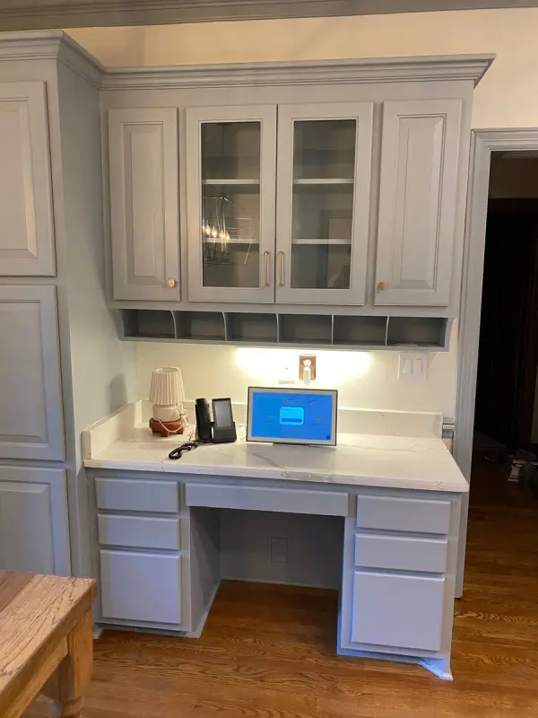 Gray built-in desk and glass-front uppers seen straight on, Brentwood, TN