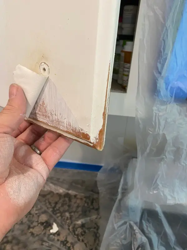 Old cabinet door edge worn through to bare wood, Bellevue, TN