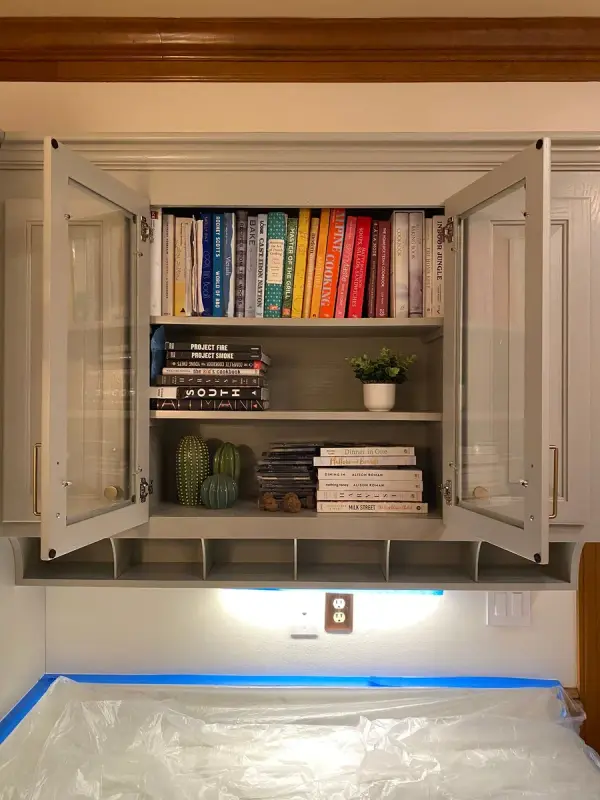Open glass-front upper cabinet with counter masked below, Brentwood, TN