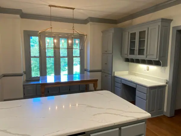 Gray island and built-in desk with breakfast-room windows beyond, Brentwood, TN