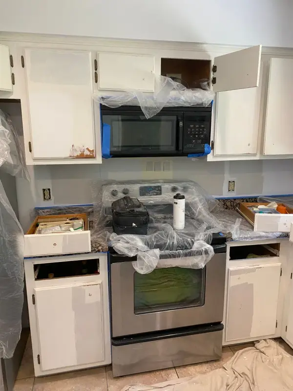 Kitchen mid-project with doors off and range under plastic, Bellevue, TN