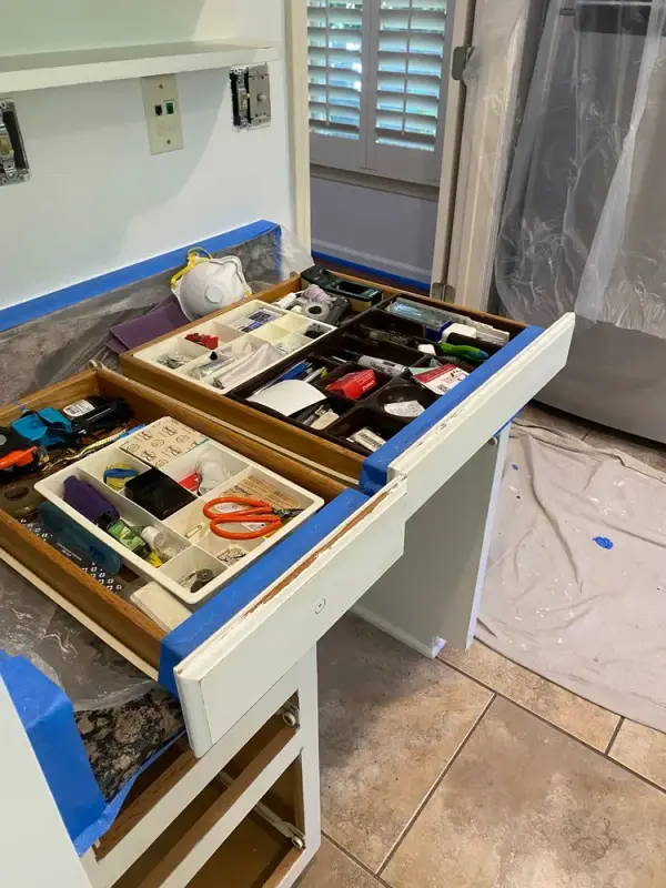 Open drawer and cabinet base masked with blue tape, Bellevue, TN