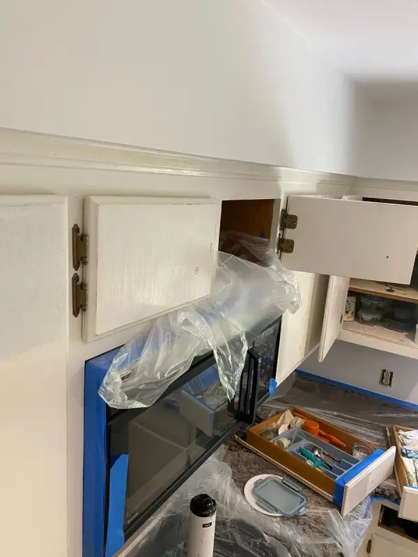 Upper cabinet doors open over a masked counter, Bellevue, TN
