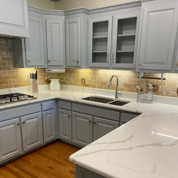 Corner run of gray cabinets with glass-front uppers over tile backsplash, Brentwood, TN