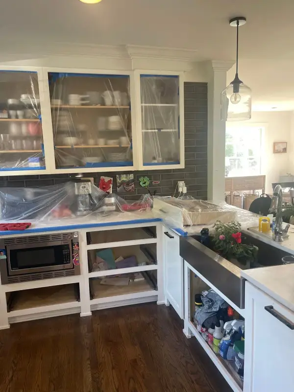 Lower cabinets with doors off and uppers masked in plastic, Brentwood, TN