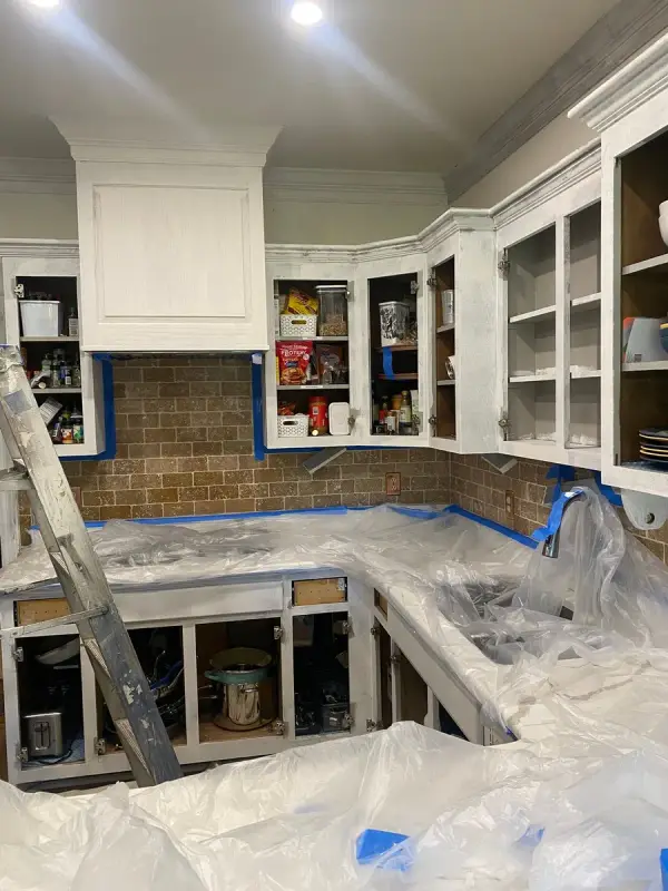 White-primed uppers with doors off and a ladder in a masked kitchen, Brentwood, TN