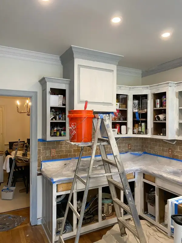 Ladder and bucket in a masked kitchen with uppers primed white, Brentwood, TN