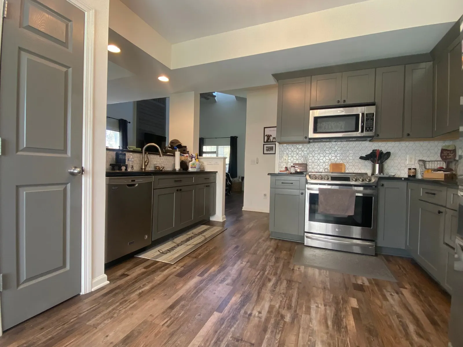 Gray-green kitchen seen through a doorway with plank floors, Franklin, TN