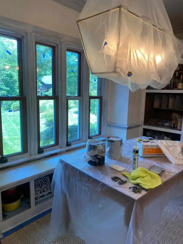 Breakfast room masked in plastic with paint supplies on covered table, Brentwood, TN