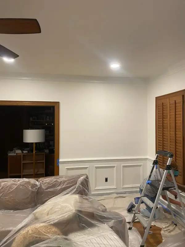 Room with white wainscoting, furniture under plastic and a stepladder, Brentwood, TN