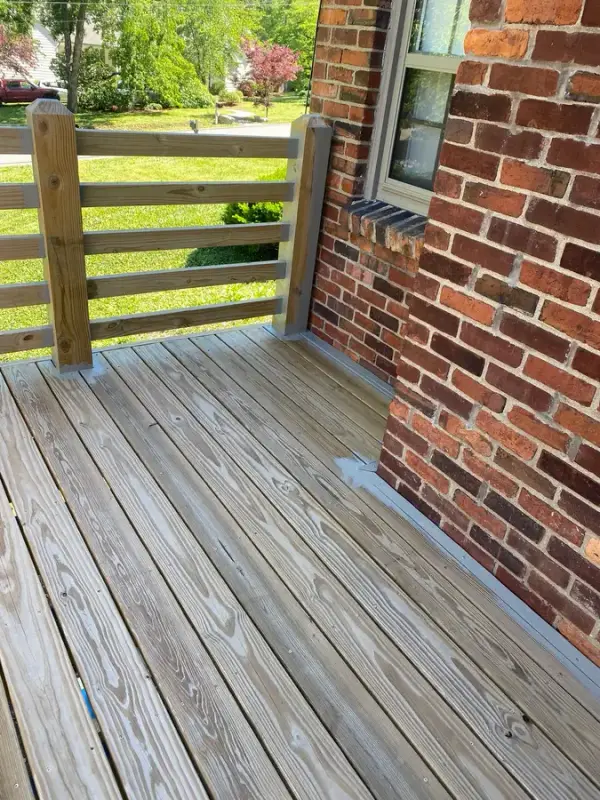 Bare deck boards beside a brick wall and railing, Belle Meade, TN