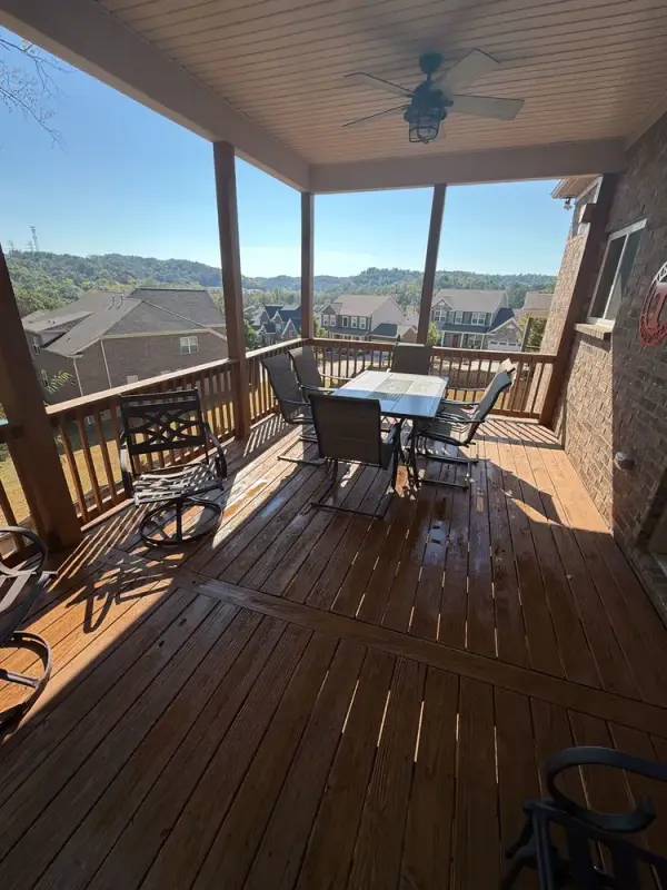 Covered deck with brown-stained boards and railing, Bellevue, TN