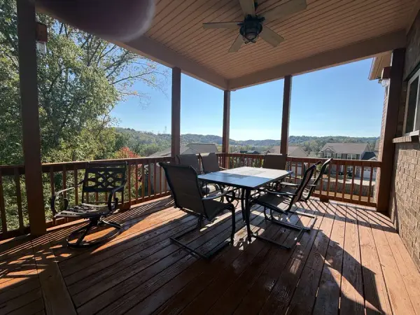 Covered deck with stained boards and hillside view, Bellevue, TN