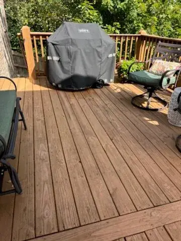 Stained deck boards beside a covered grill, Bellevue, TN