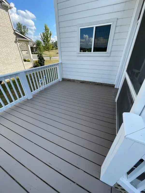 Brown-gray deck boards beside white railings and siding, Bellevue, TN