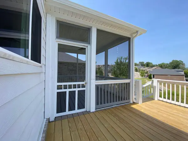 Light bare boards beside a white screen door and railing, Bellevue, TN