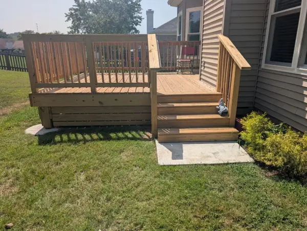 Stained deck stair with railings beside a planting bed, Bellevue, TN