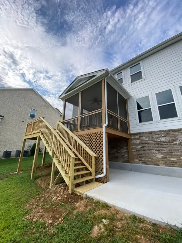 Bare-wood stair and lattice beside a new patio, Bellevue, TN