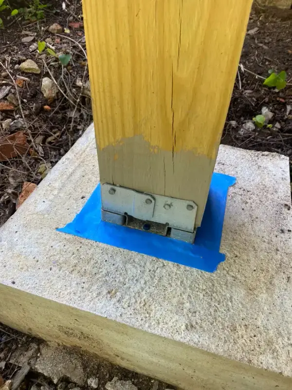 Support post half stained with tape around its base bracket, Belle Meade, TN