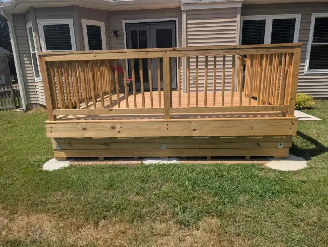 Honey-stained deck with square balusters across the back of a house, Bellevue, TN