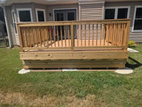 Honey-stained deck with square balusters across the back of a house, Bellevue, TN