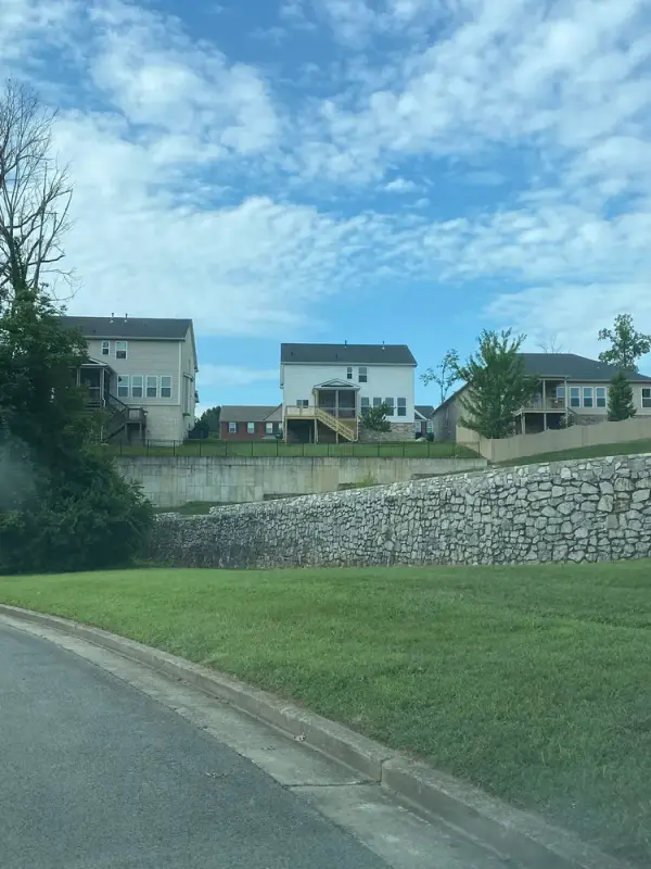 Street view toward the house across a retaining wall, Bellevue, TN