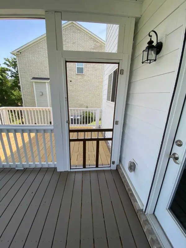 White screen door opening to a brown-gray deck, Bellevue, TN