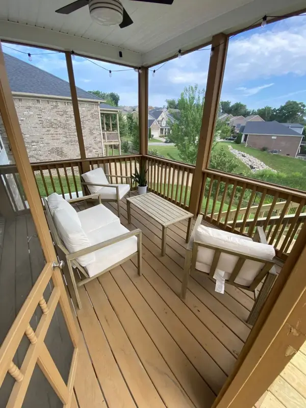 Screened porch with brown posts and light boards, Bellevue, TN