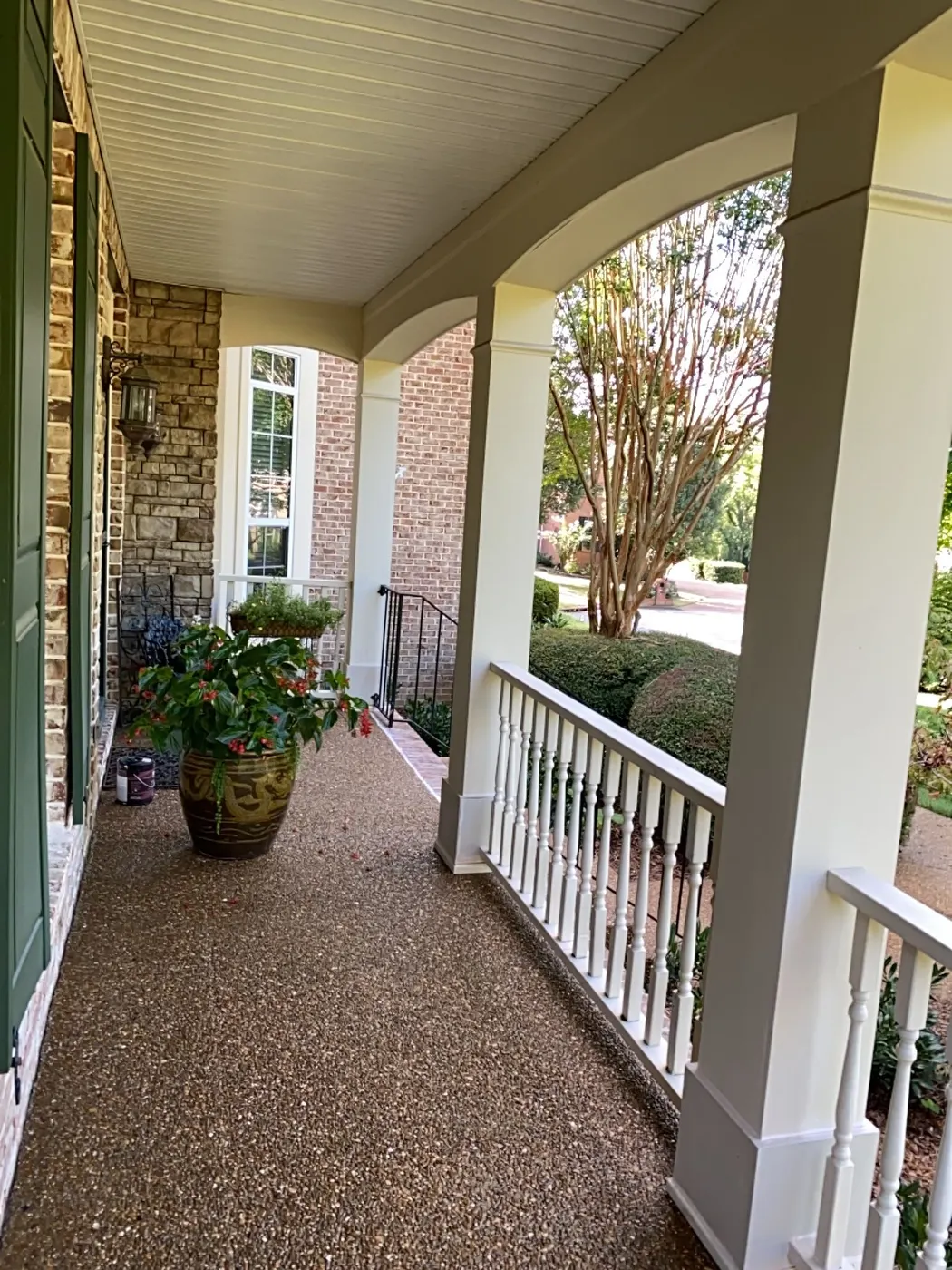 Covered porch with white columns, arched beams and white railing, Bellevue, TN