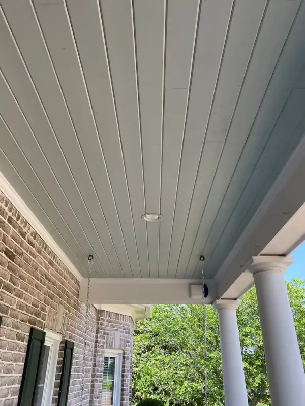 Pale blue porch ceiling above round white columns and shutters, Franklin, TN