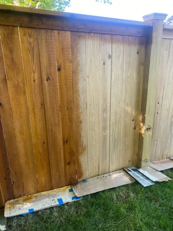 Fence panel half stained with cardboard protecting the base, Thompson Station, TN
