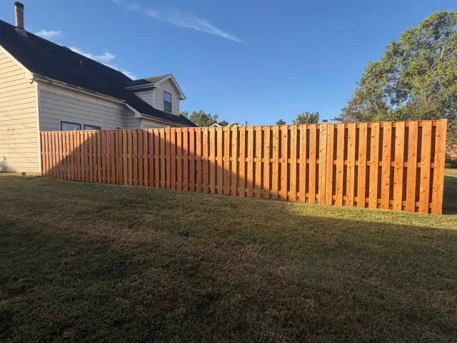 Stained privacy fence across the back of a lawn, Bellevue, TN