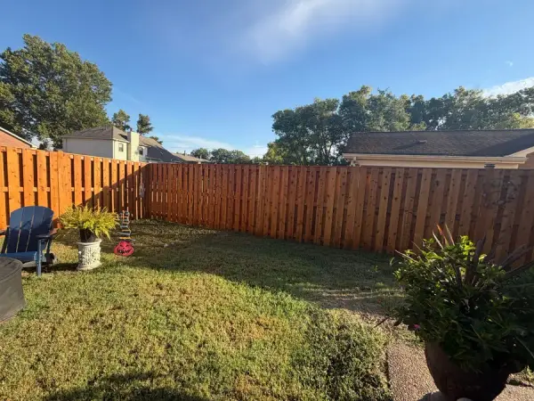 Cedar-orange stained privacy fence around a backyard patio, Bellevue, TN