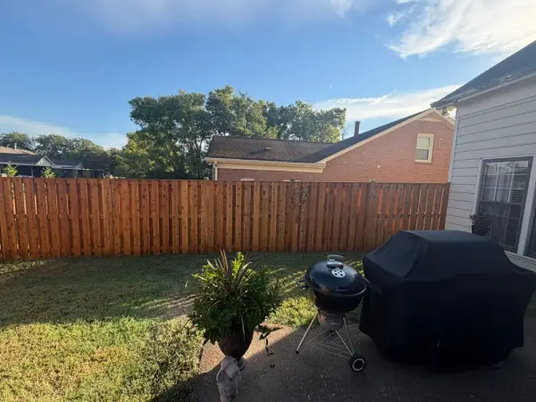 Stained privacy fence behind a grill and planters, Bellevue, TN