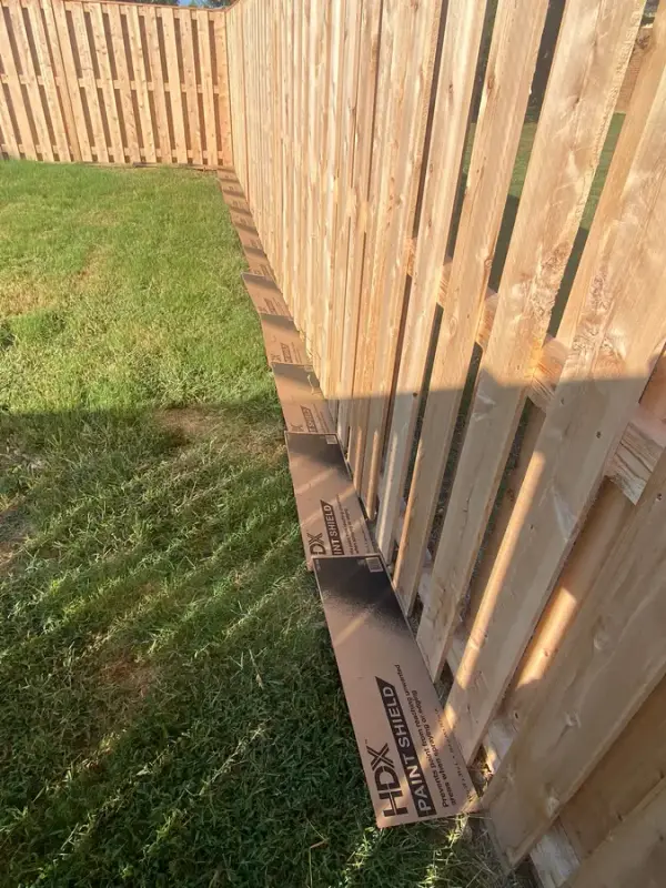 Raw fence boards with cardboard along the base, Bellevue, TN