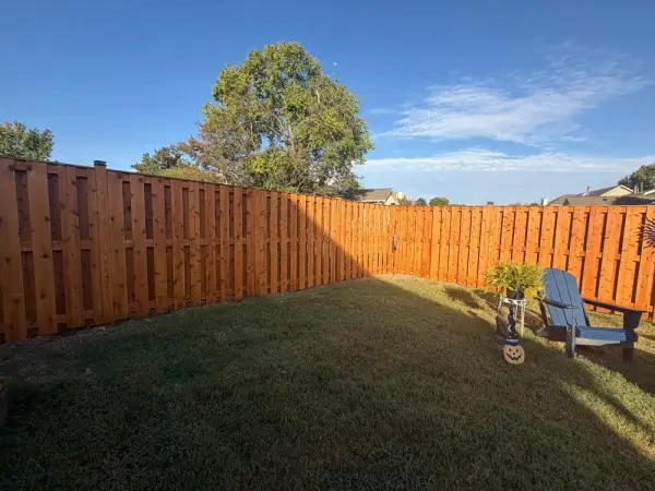 Long run of cedar-orange stained board-on-board fence, Bellevue, TN