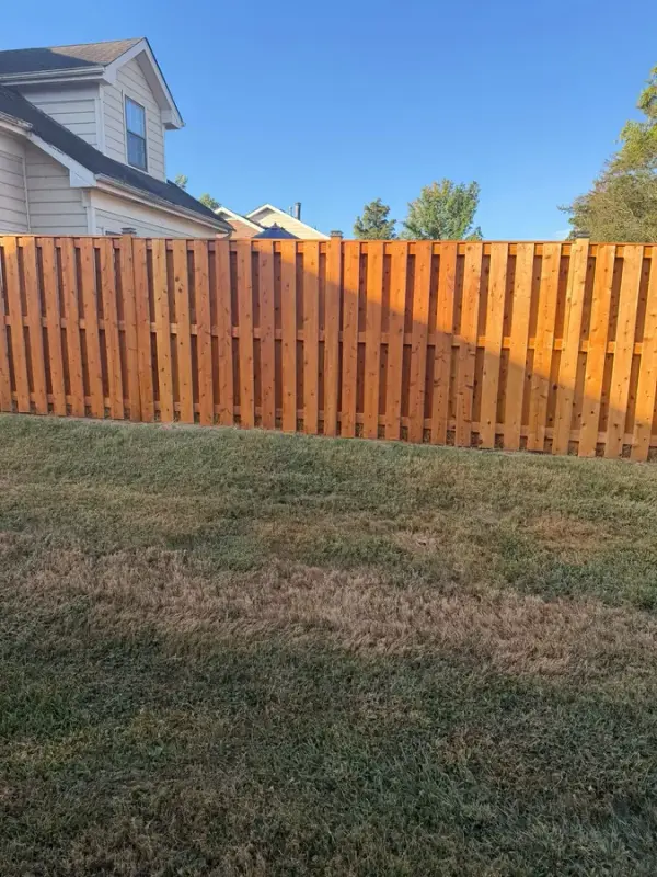 Cedar-orange privacy fence behind a lawn, upright view, Bellevue, TN
