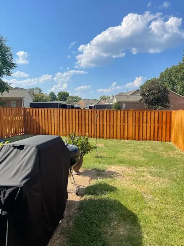 Stained fence behind a covered grill, Bellevue, TN