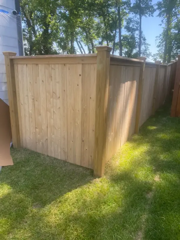 Raw unstained privacy fence corner on new sod, Thompson Station, TN