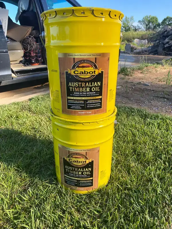 Two pails of Cabot Australian Timber Oil on the lawn, Thompson Station, TN