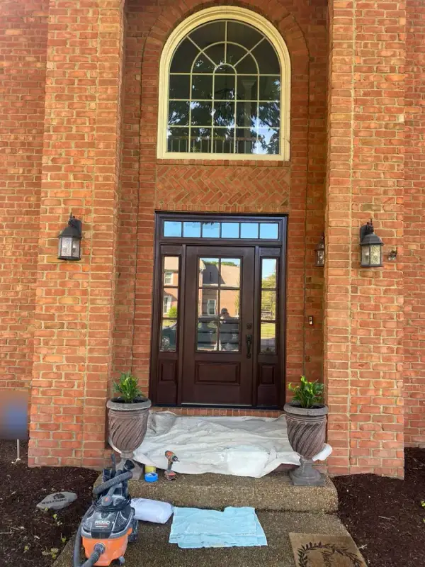 Two-story brick entry with stained door under an arched window, Franklin, TN