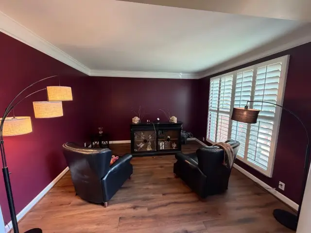 Deep burgundy sitting room with white crown and shutters, Bellevue, TN