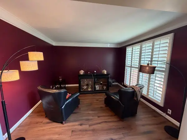 Deep burgundy sitting room with white crown and shutters, Bellevue, TN