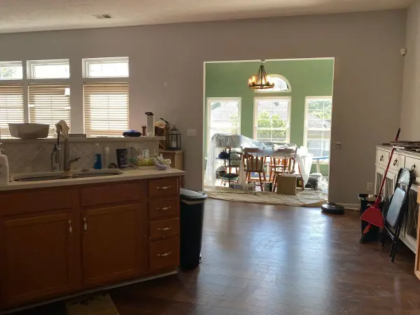 Kitchen with tan walls opening to a dark green breakfast room, Bellevue, TN