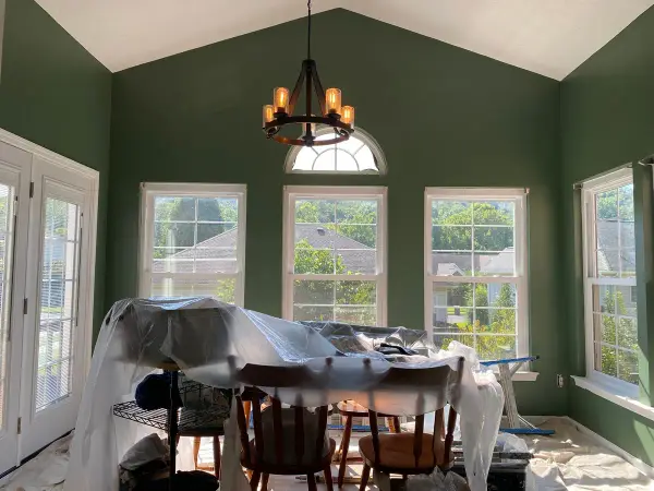 Dark green vaulted breakfast room with the table under plastic, Bellevue, TN