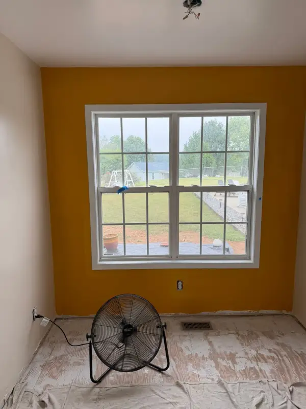 Marigold accent wall with a fan on the floor, Pleasant View, TN