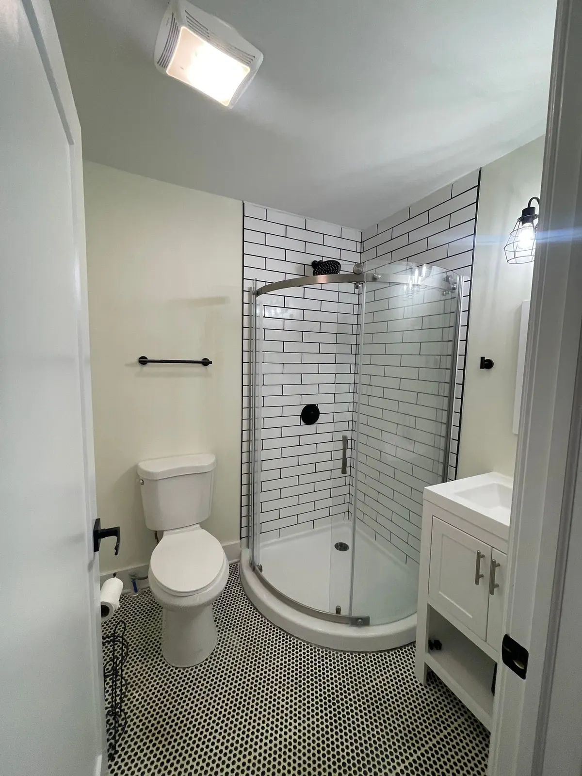 White bathroom with subway-tile corner shower and hex floor, Belle Meade, TN