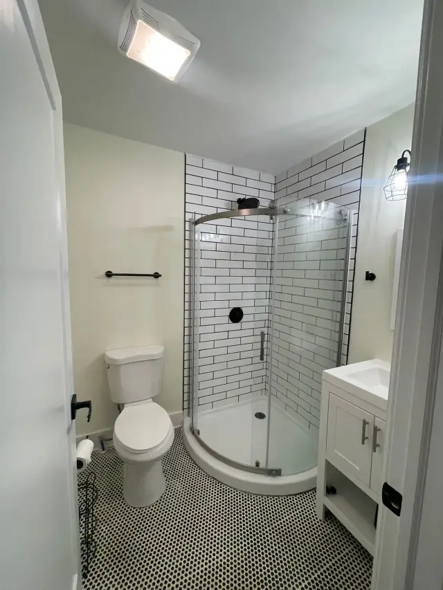 White bathroom with subway-tile corner shower and hex floor, Belle Meade, TN