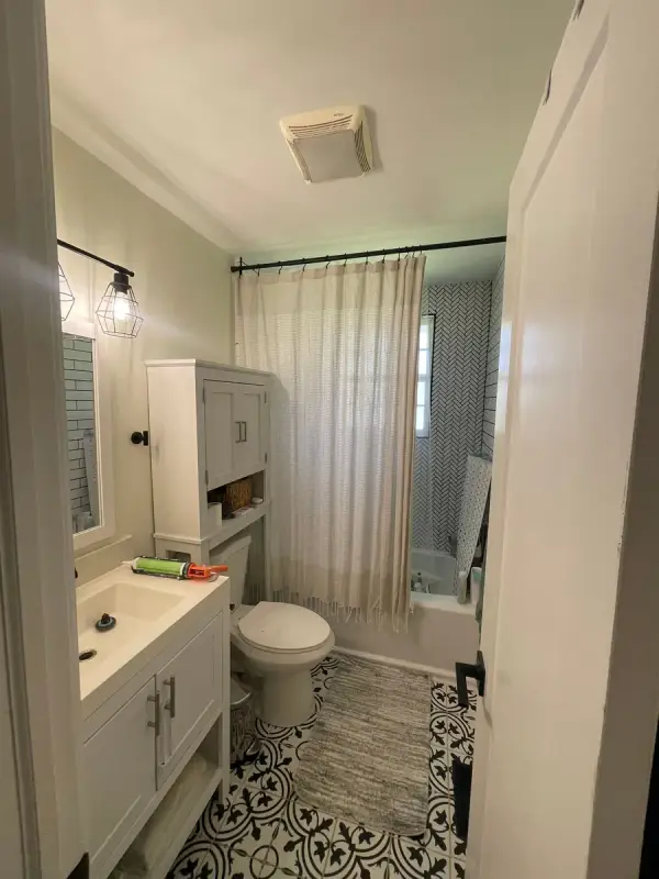 White bathroom with vanity, wall cabinet and patterned tile floor, Belle Meade, TN